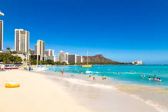 Waikiki Beach shoreline with hotel skyline and Diamond Head in the distance